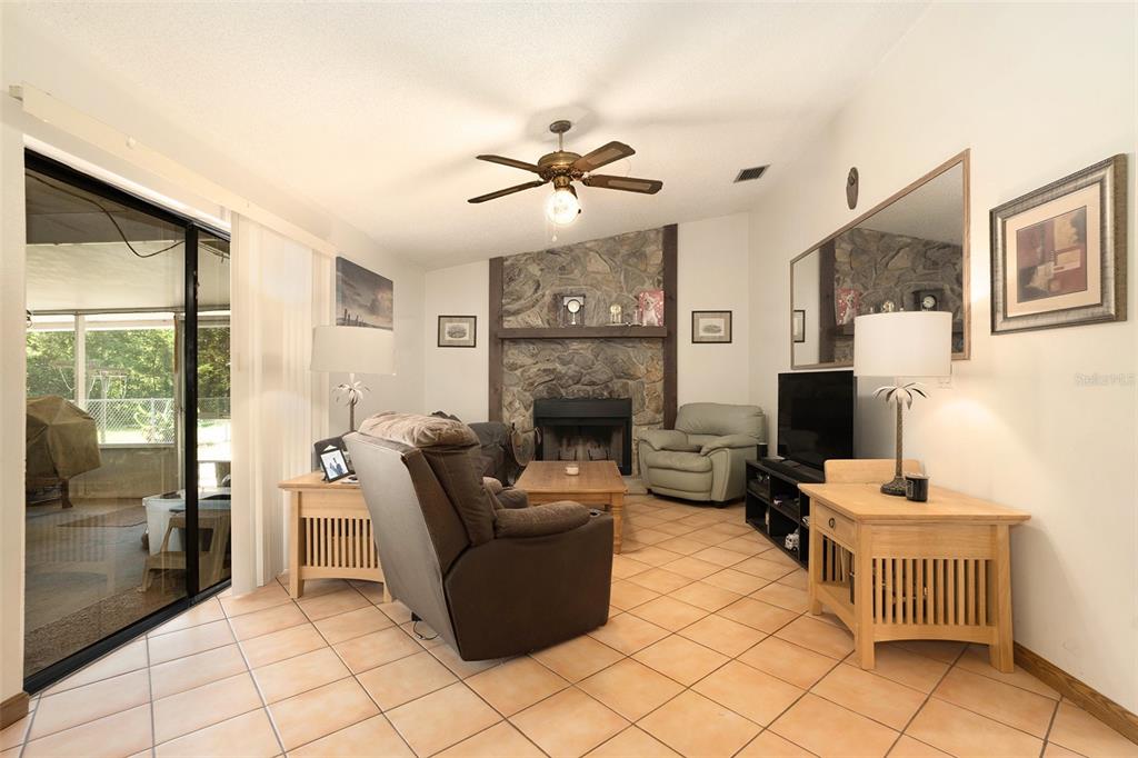 5960 Boyette Road Wesley Chapel, FL 33543 - Photo 12 of 32 a living room with furniture and a fireplace