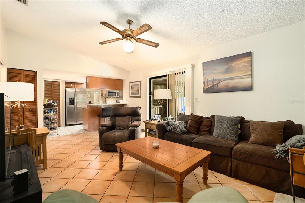 5960 Boyette Road Wesley Chapel, FL 33543 - Photo 13 of 32 a living room with furniture and a view of kitchen