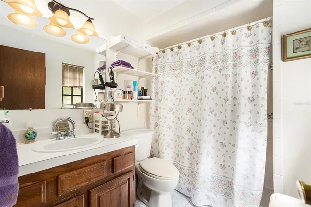 a bathroom with a sink vanity mirror and toilet