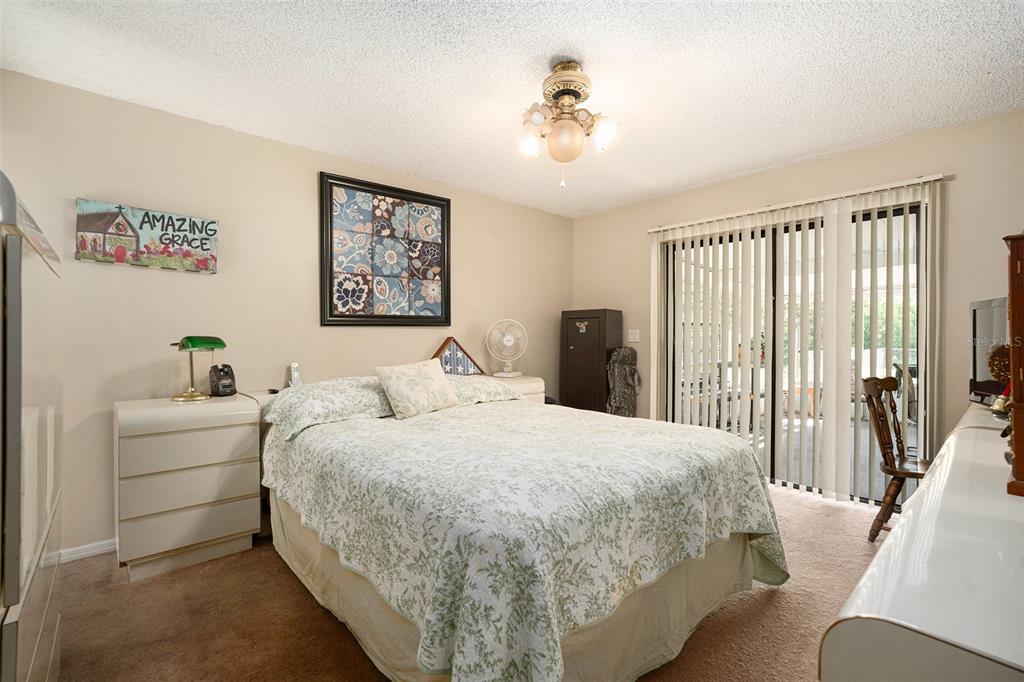 5960 Boyette Road Wesley Chapel, FL 33543 - Photo 15 of 32 a bedroom with a bed and a chandelier