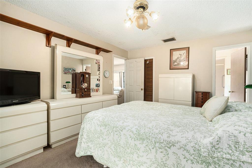 5960 Boyette Road Wesley Chapel, FL 33543 - Photo 16 of 32 a bedroom with a bed and a flat screen tv