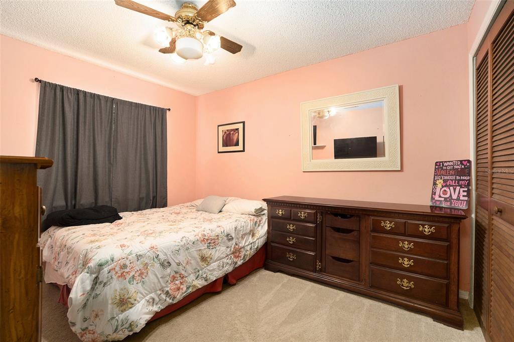 5960 Boyette Road Wesley Chapel, FL 33543 - Photo 18 of 32 a bedroom with a bed and a dresser