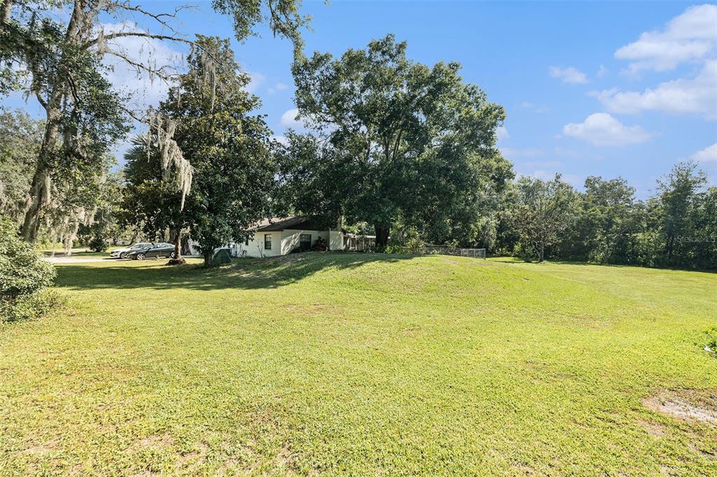 5960 Boyette Road Wesley Chapel, FL 33543 - Photo 27 of 32 a view of a swimming pool with an outdoor space and seating area