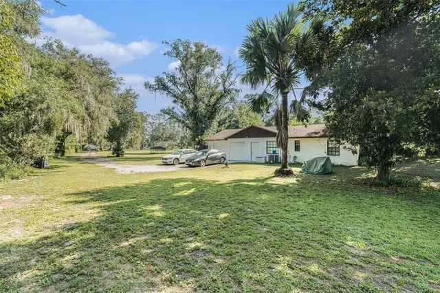 a view of a house with swimming pool and sitting area