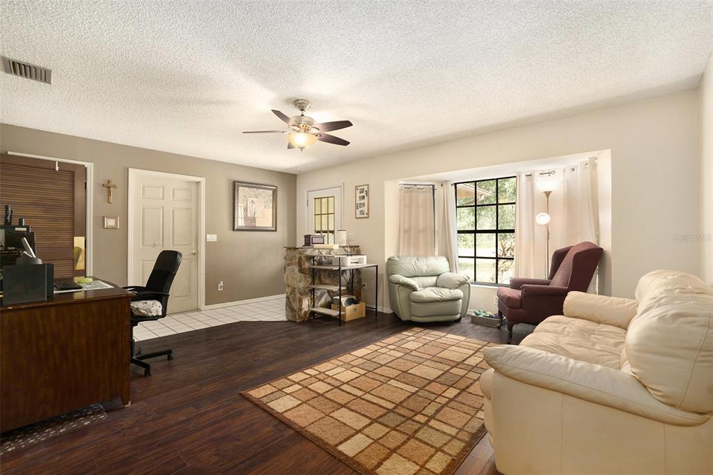 5960 Boyette Road Wesley Chapel, FL 33543 - Photo 4 of 32 a living room with furniture and wooden floor