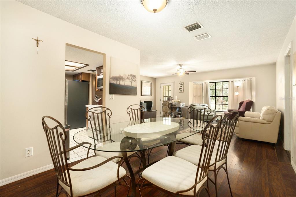 5960 Boyette Road Wesley Chapel, FL 33543 - Photo 7 of 32 a view of a dining room with furniture and wooden floor
