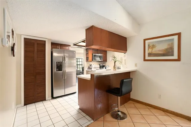 a kitchen with stainless steel appliances a refrigerator and a sink