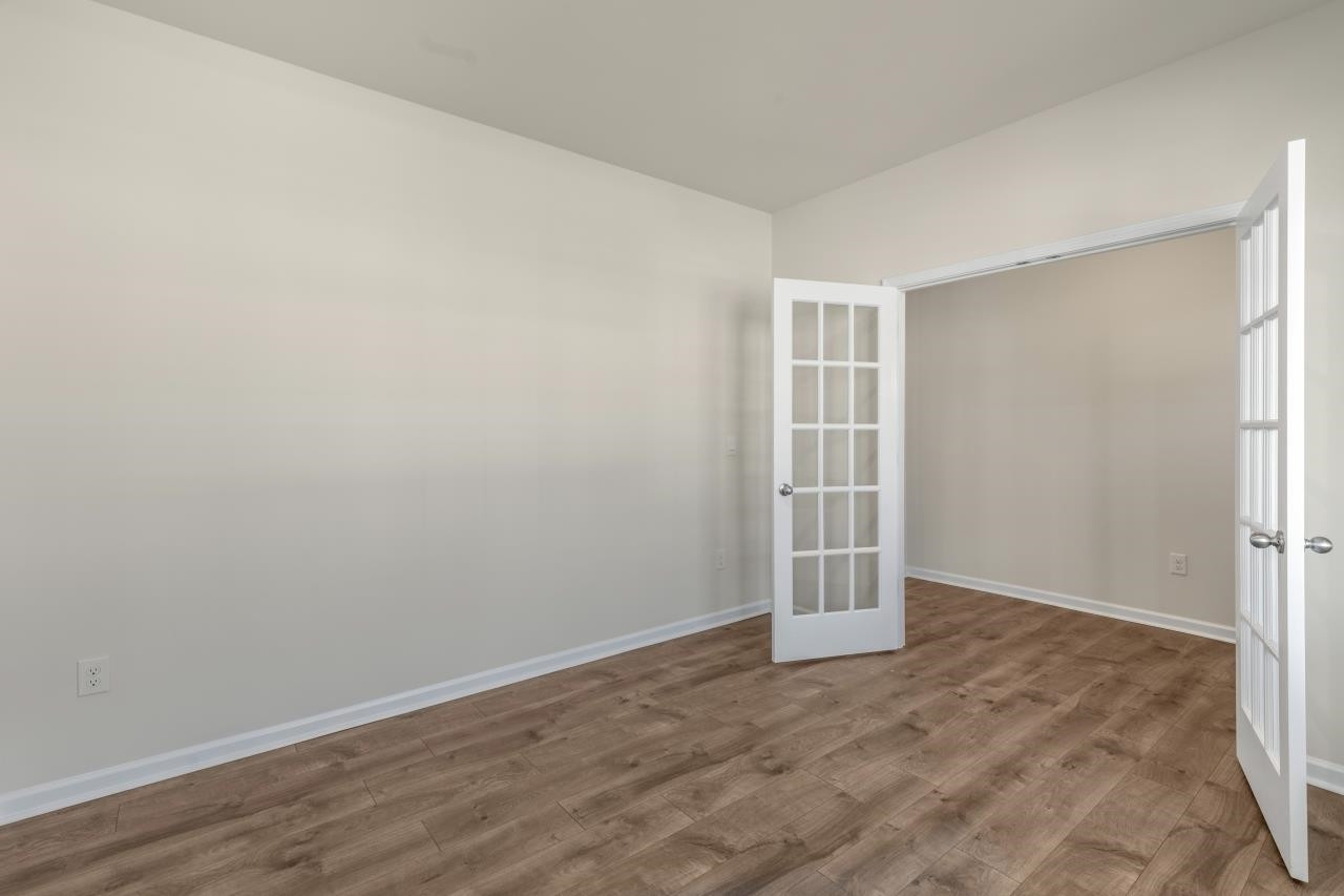 2129 Clydesmill Road Fayetteville, NC 28314 - Photo 13 of 37 an empty room with wooden floor and windows
