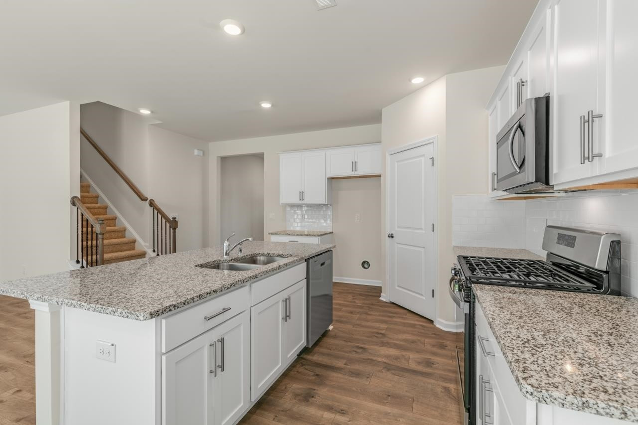 2129 Clydesmill Road Fayetteville, NC 28314 - Photo 16 of 37 a kitchen with stainless steel appliances granite countertop a sink stove and cabinets