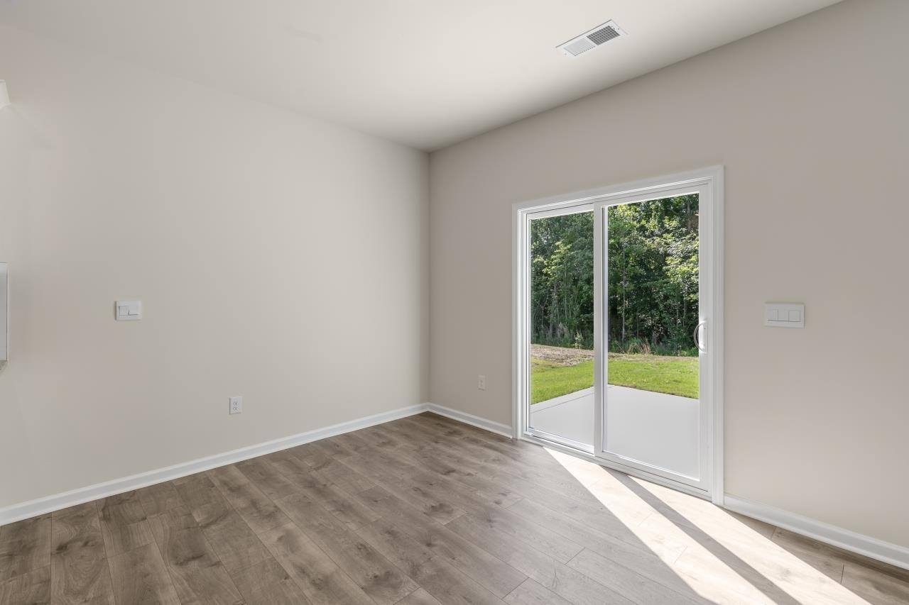 2129 Clydesmill Road Fayetteville, NC 28314 - Photo 18 of 37 a view of an empty room with wooden floor and a window