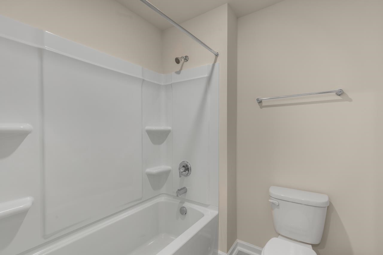 2129 Clydesmill Road Fayetteville, NC 28314 - Photo 35 of 37 a bathroom with a toilet and a bathtub