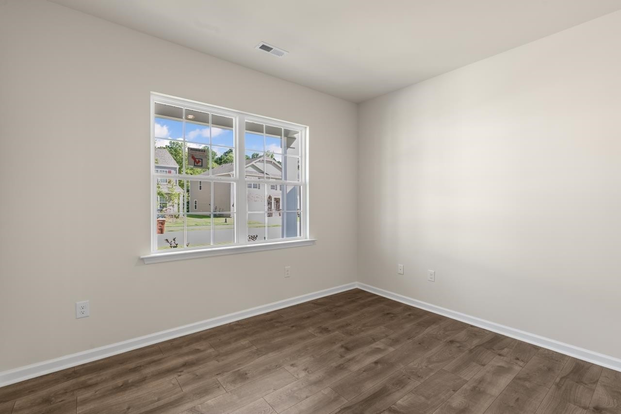 2129 Clydesmill Road Fayetteville, NC 28314 - Photo 10 of 37 an empty room with wooden floor and windows