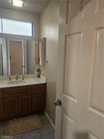 a bathroom with a double vanity sink and a mirror