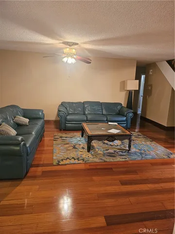 a living room with furniture and wooden floor