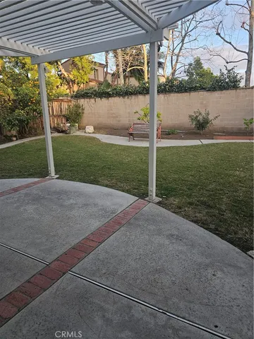 a view of a house with backyard and a porch