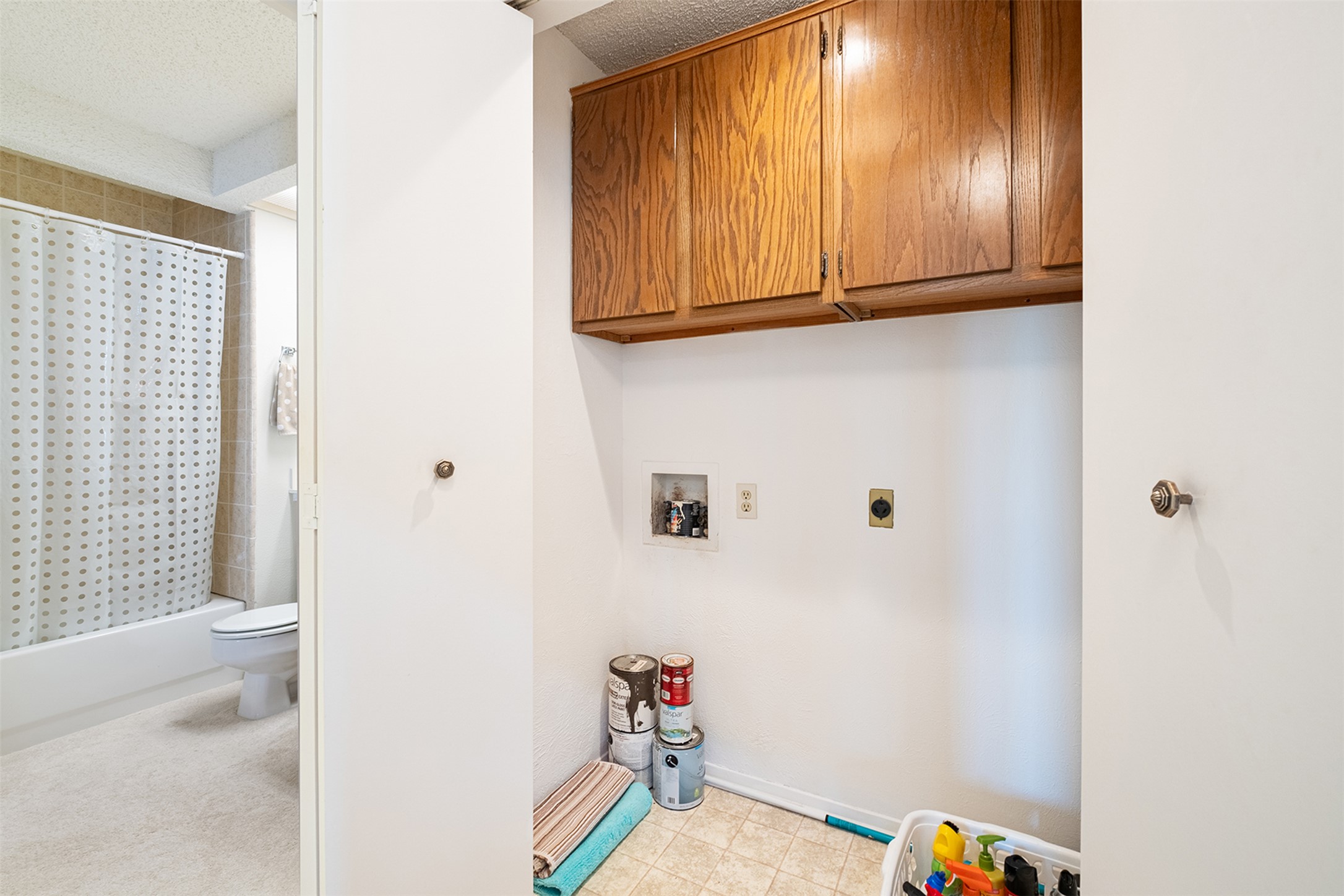 1748 Ohlen Road, Unit 16 Austin, TX 78757 - Photo 22 of 38 Laundry room featuring a textured ceiling, hookup for a washing machine, cabinet space, hookup for an electric dryer, and light flooring