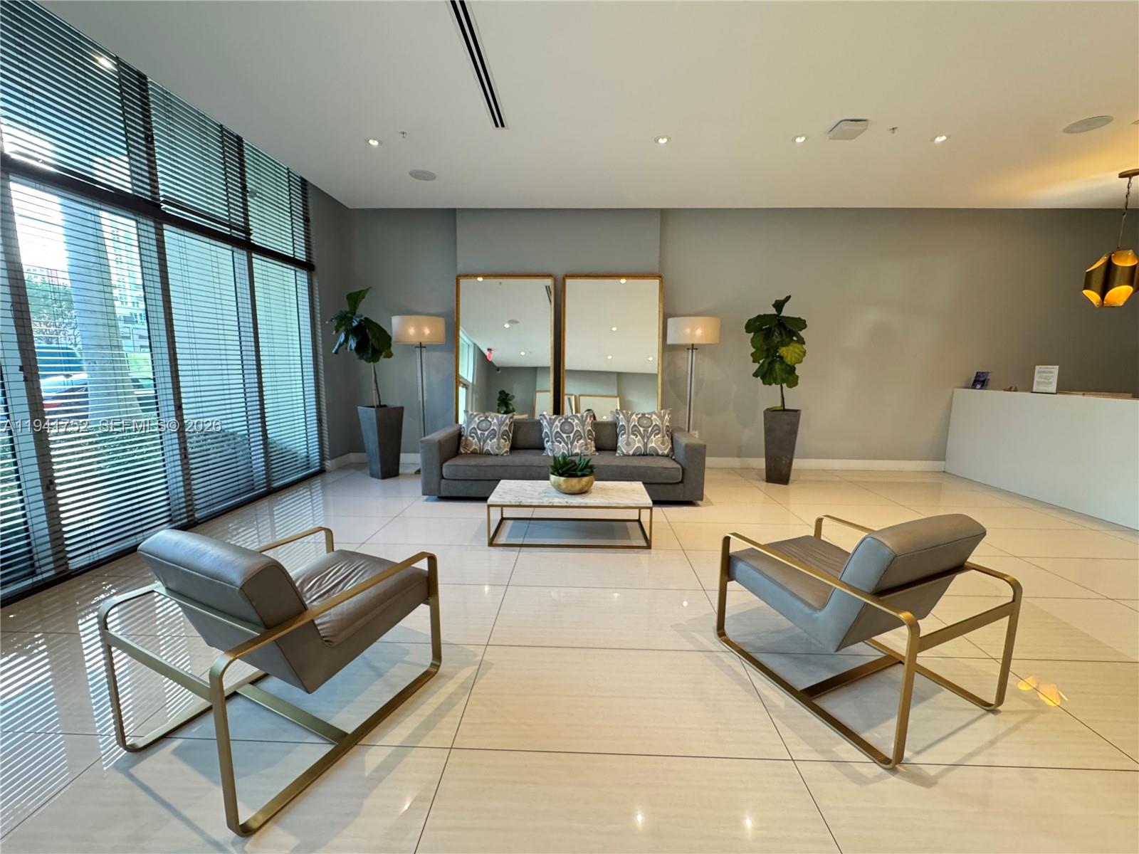 321 Northeast 26th Street, Unit 615 Miami, FL 33137 - Photo 12 of 22 a living room with furniture and a large window