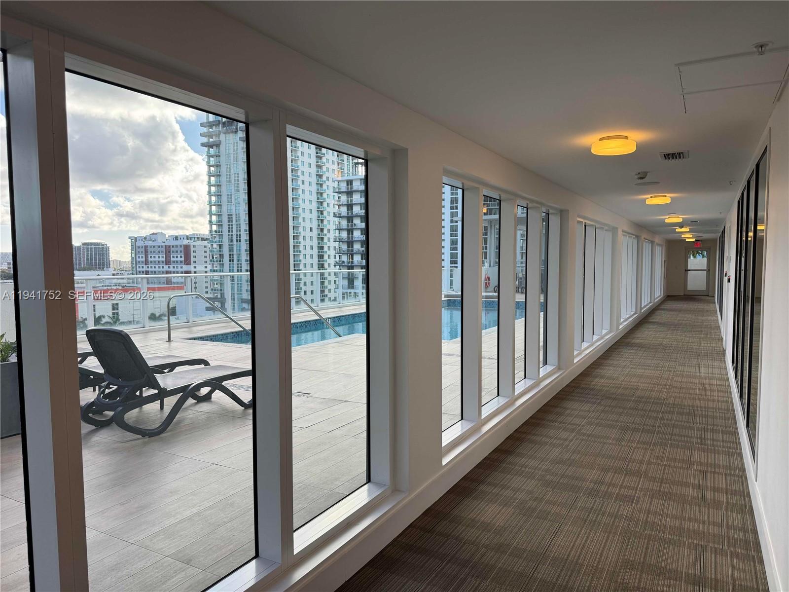 321 Northeast 26th Street, Unit 615 Miami, FL 33137 - Photo 16 of 22 a view of a hallway to a livingroom with furniture