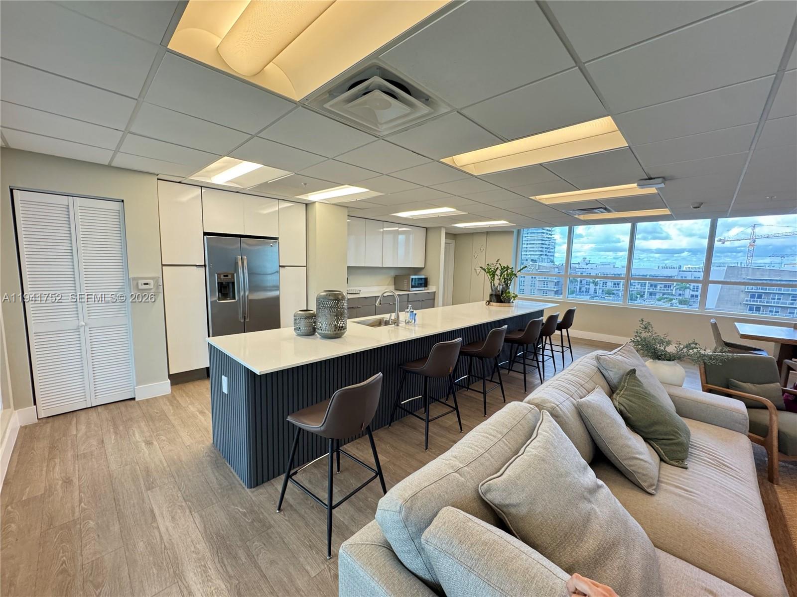 321 Northeast 26th Street, Unit 615 Miami, FL 33137 - Photo 18 of 22 a open kitchen with stainless steel appliances kitchen island granite countertop a table chairs sink and window