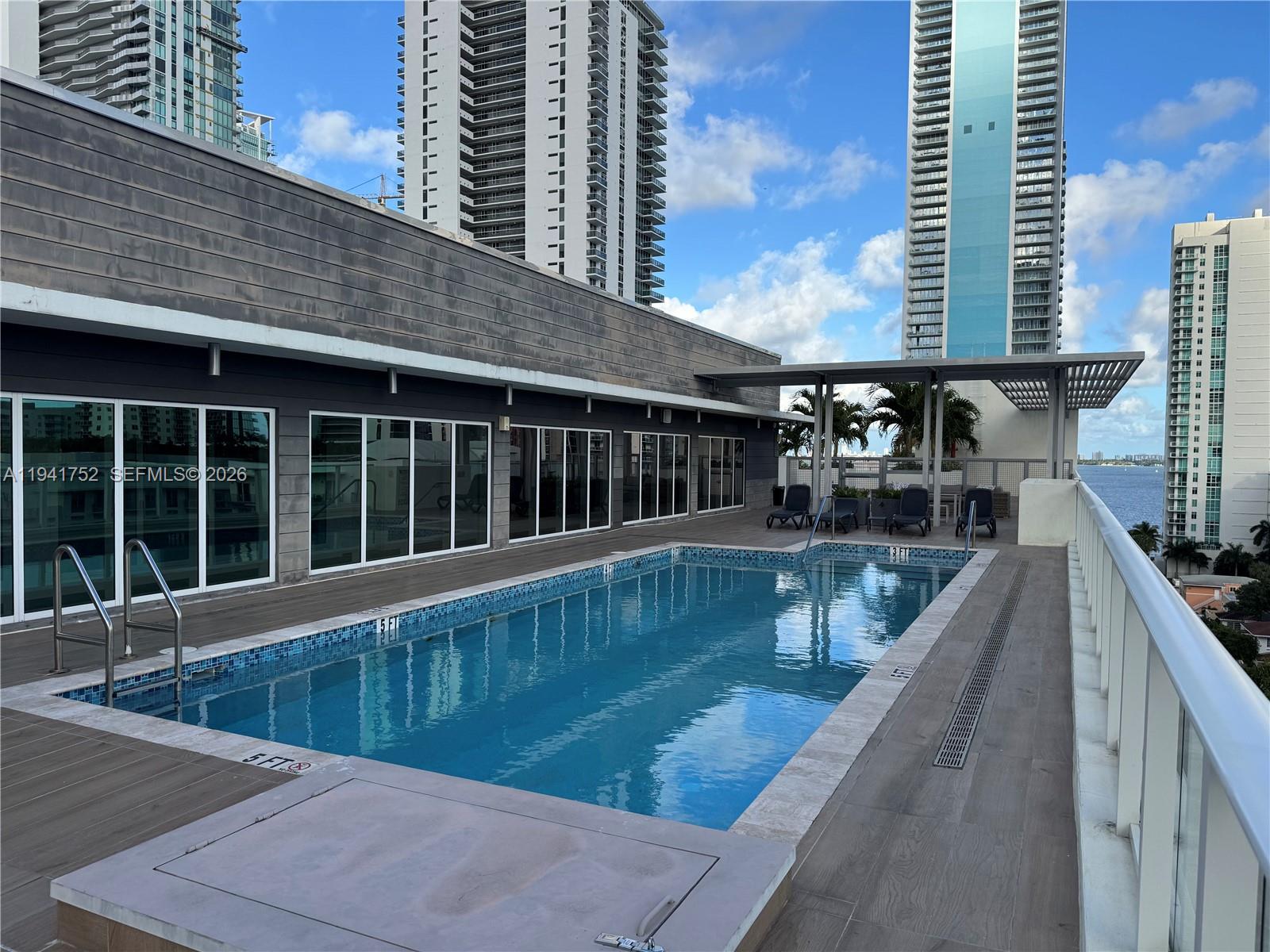 321 Northeast 26th Street, Unit 615 Miami, FL 33137 - Photo 20 of 22 a view of balcony with two large window and chairs