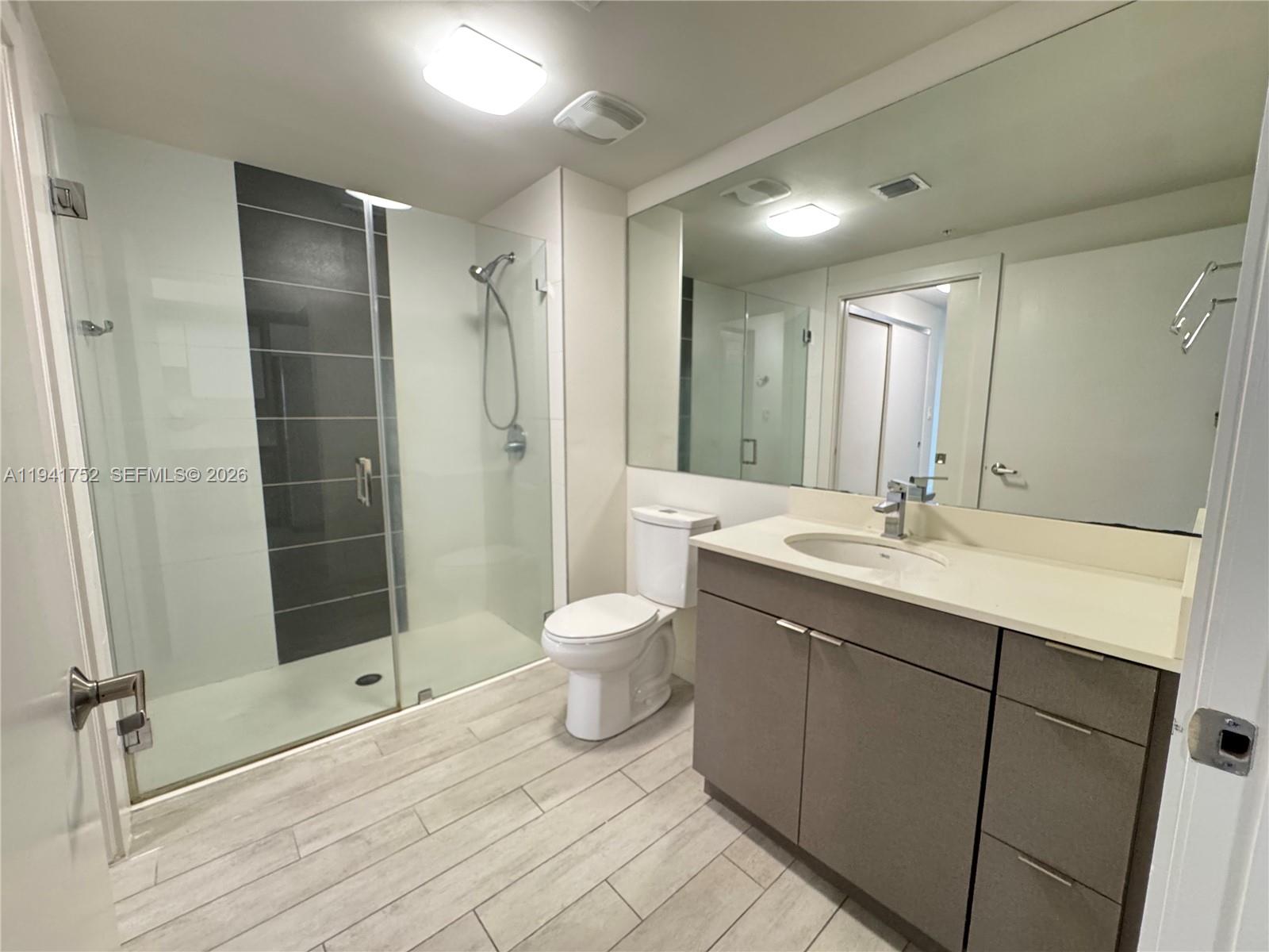 321 Northeast 26th Street, Unit 615 Miami, FL 33137 - Photo 6 of 22 a bathroom with a double vanity sink toilet and shower