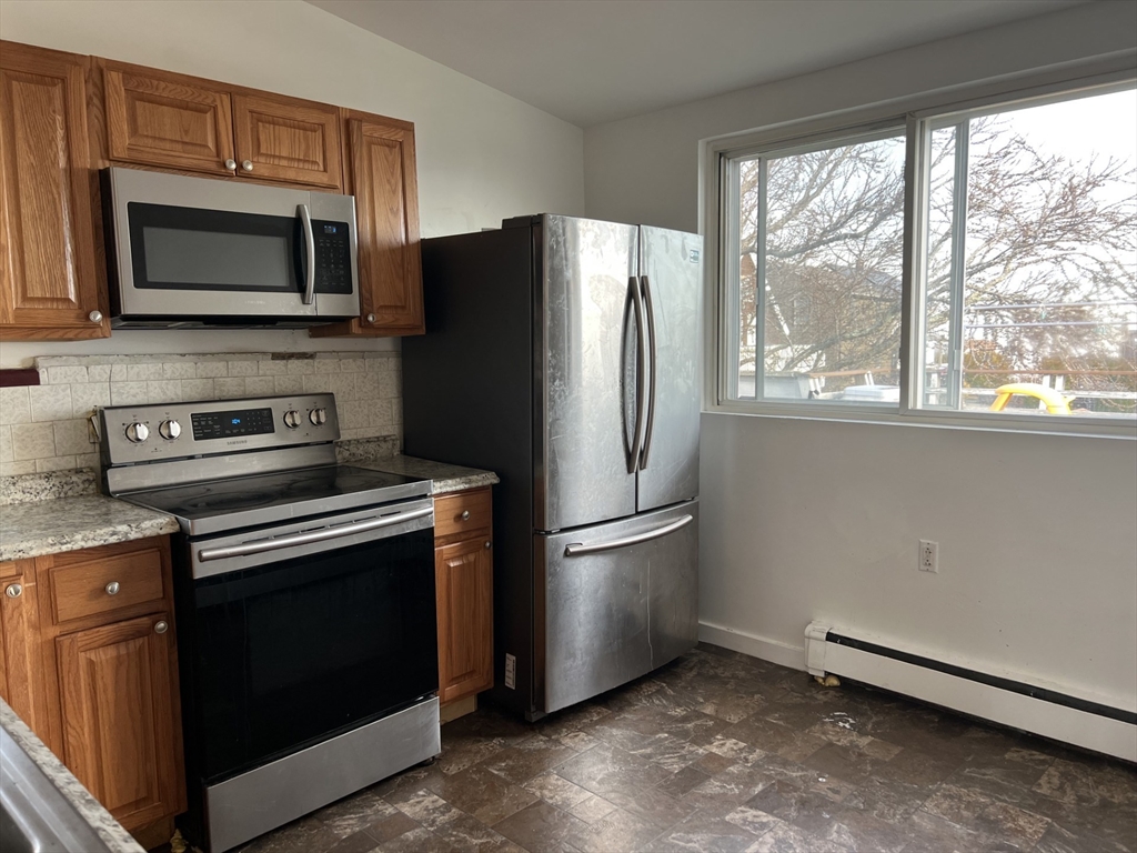 49 R Siren Street, Unit 3 Winthrop, MA 02152 - Photo 3 of 12 a kitchen with a refrigerator stove and microwave
