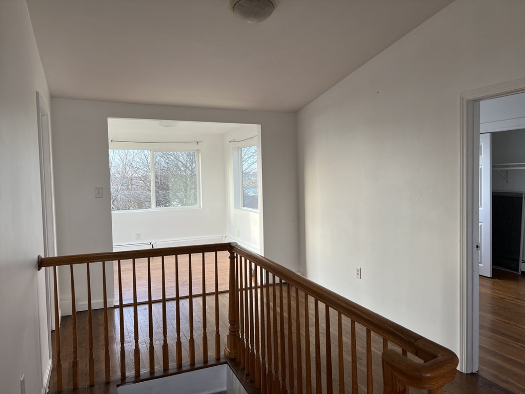 49 R Siren Street, Unit 3 Winthrop, MA 02152 - Photo 6 of 12 a view of a hallway with wooden floor and a window