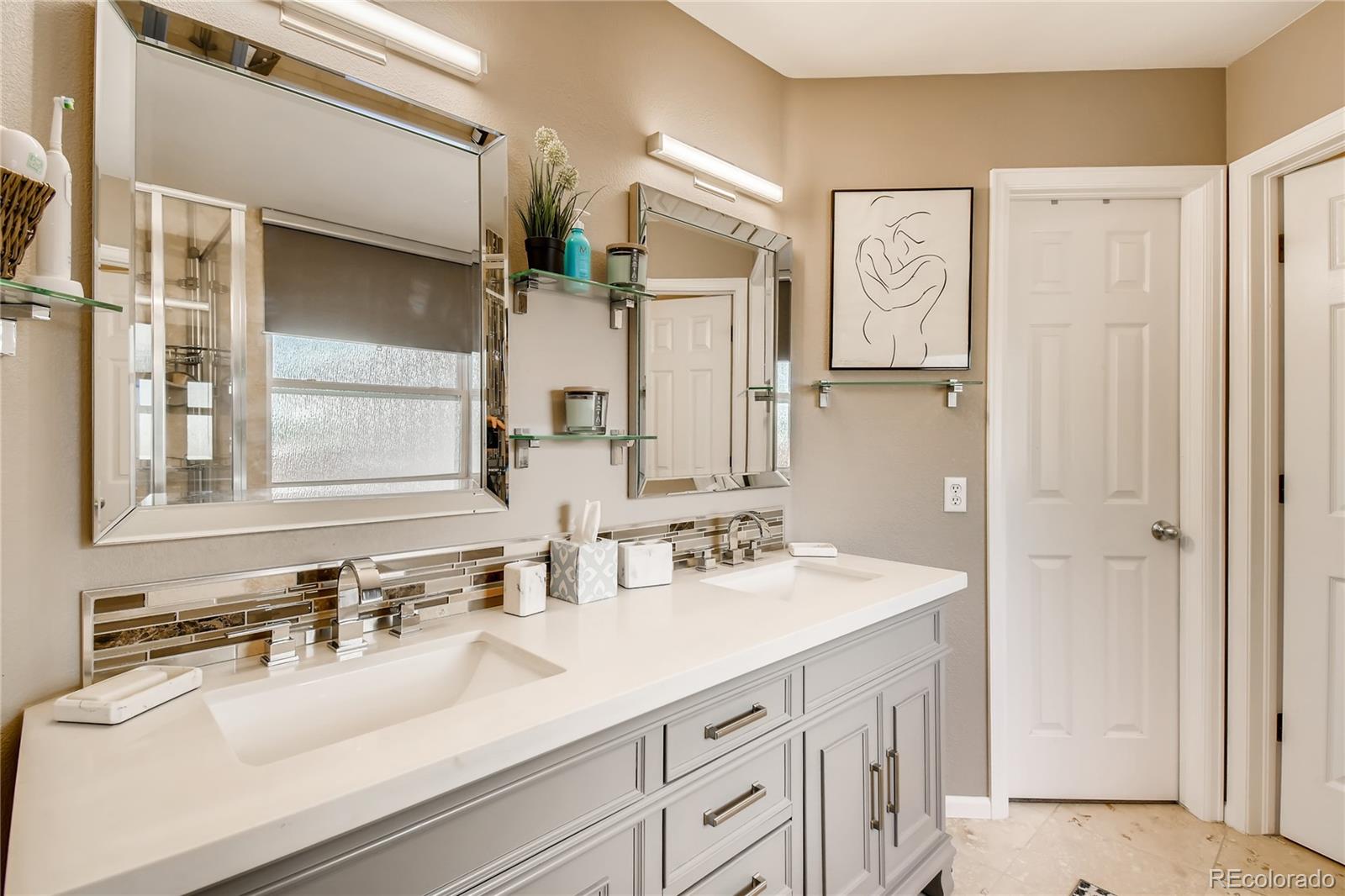 9879 Concord Court Highlands Ranch, CO 80130 - Photo 16 of 36 a bathroom with a sink double vanity and a mirror