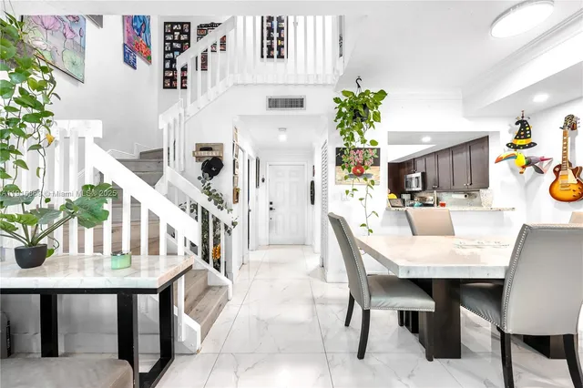 a dining room with furniture and wooden floor