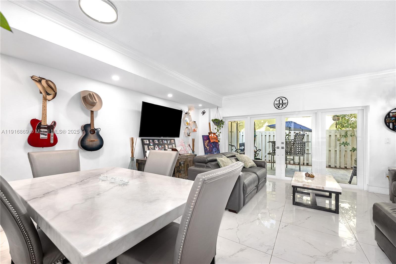 9985 Southwest 118th Place Miami, FL 33186 - Photo 16 of 30 a living room with furniture and a flat screen tv