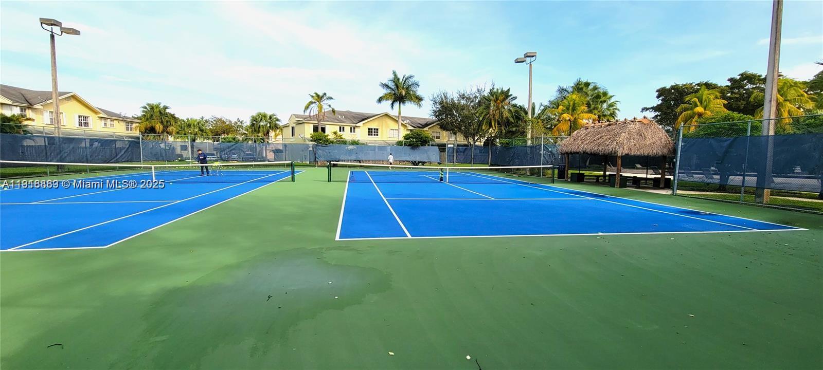 9985 Southwest 118th Place Miami, FL 33186 - Photo 2 of 30 a view of an outdoor space and tennis court