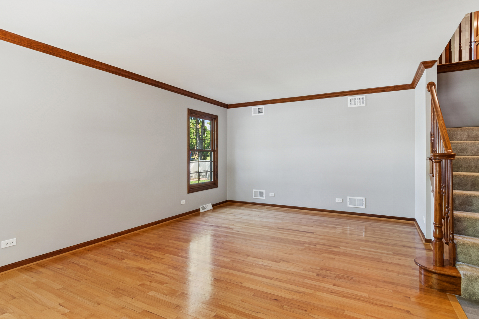 2230 Keim Road Naperville, IL 60565 - Photo 6 of 33 a view of an empty room with wooden floor and a window