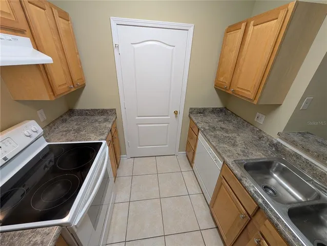 a kitchen with a stove microwave and sink