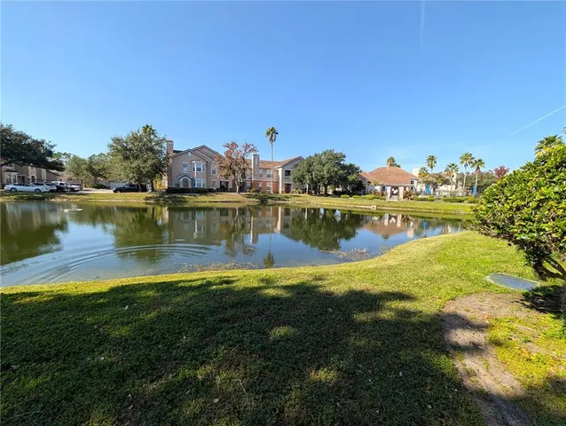 a view of a lake with houses in the back
