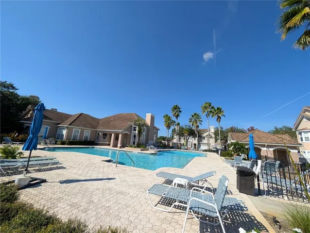 a view of a patio with a table and chairs