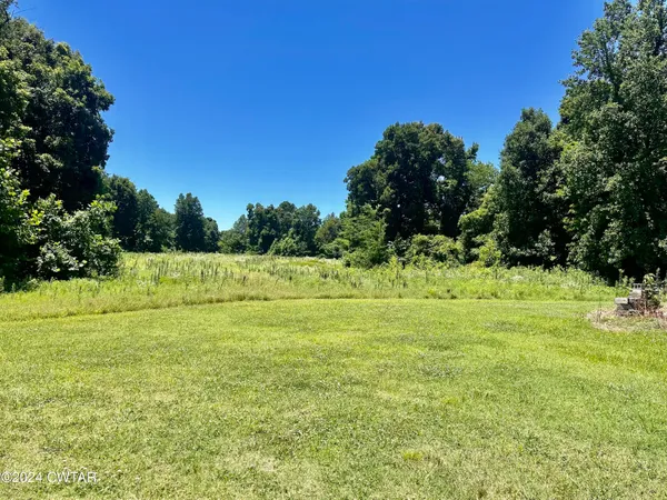 a view of a field with an trees