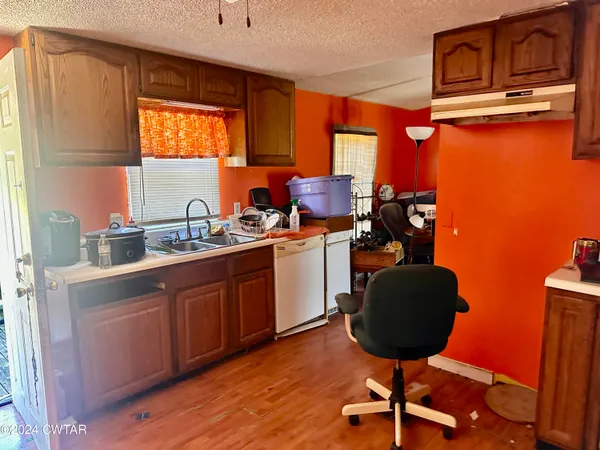 a kitchen with a sink cabinets and window