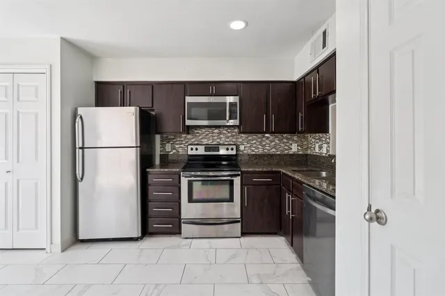 a kitchen with a refrigerator sink and microwave