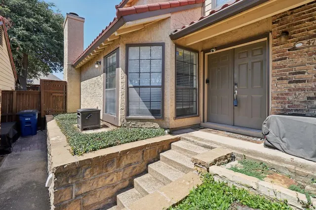 a front view of a house with outdoor seating and plants