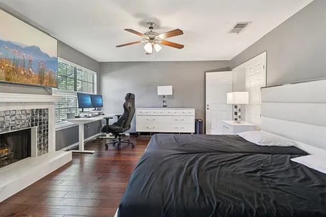 a bedroom with a bed and a fireplace