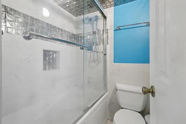 a bathroom with a toilet and a shower