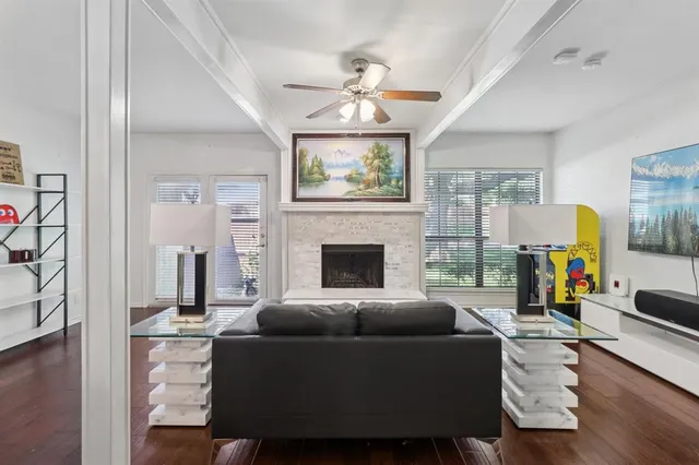 a living room with furniture a fireplace and a chandelier