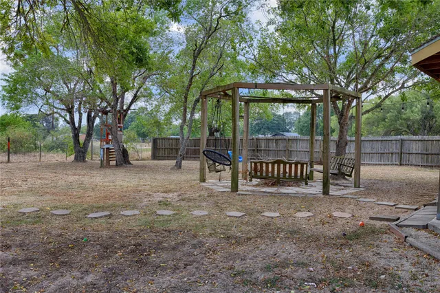 a view of a backyard with a trampoline