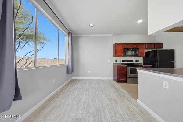 a kitchen with stainless steel appliances granite countertop a sink refrigerator and microwave