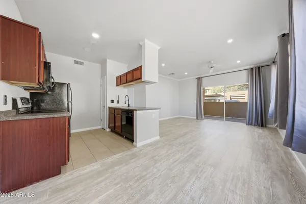 a kitchen with stainless steel appliances a refrigerator and a stove top oven
