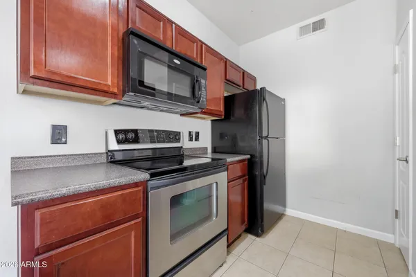 a kitchen with stainless steel appliances granite countertop a stove and a sink