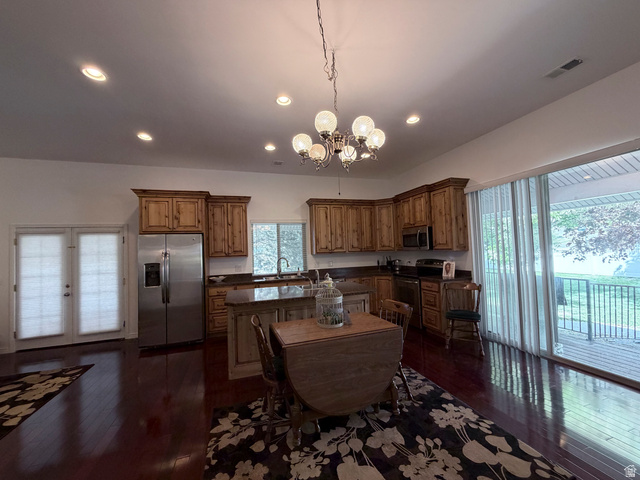 2855 South 1000 West Perry, UT 84302 - Photo 102 of 142 Kitchen with stainless steel appliances, suspended lighting, a kitchen island, dark wood finished floors, and wood finish cabinetry