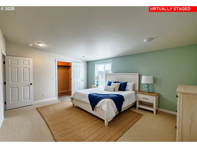 a bedroom with a large bed and a window