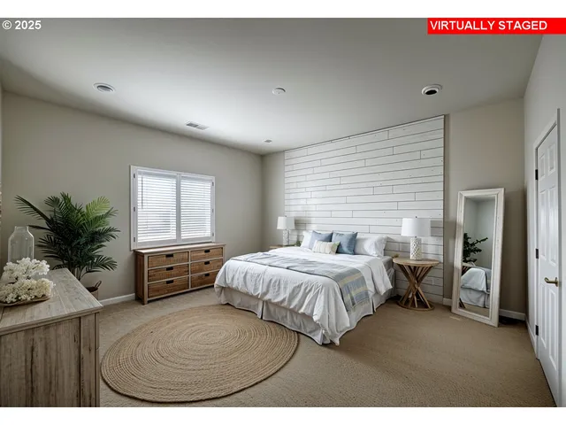 a bedroom with a large bed and a potted plant