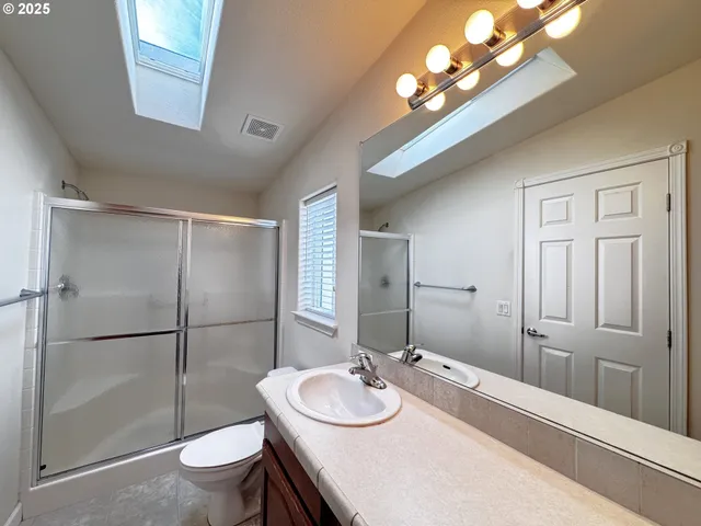 a bathroom with a sink a mirror and a shower